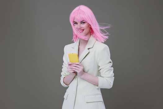 cheerful woman pink wig talking on the phone