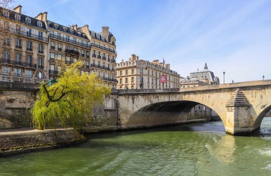 One of the oldest bridge ( Pont Royal ) across Seine River and beautiful historic buildings of Paris France. April 2019