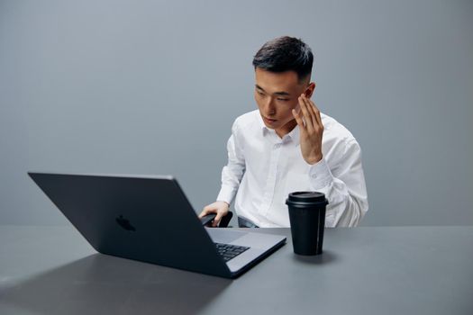 businessmen fatigue emotions laptop work coffee at the desktop Lifestyle
