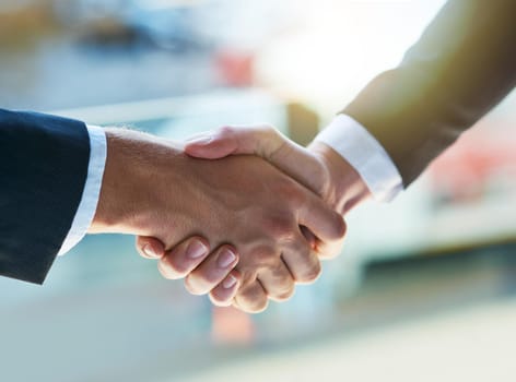Lets seal the deal. Shot of two businesspeople shaking hands.