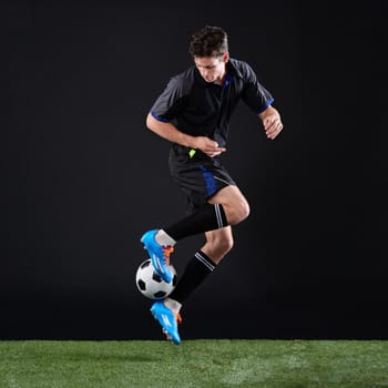 Hard work beats talent when talent doesnt work hard. Full length studio shot of a handsome young soccer player isolated on black.