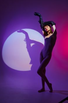 glamorous woman scene spotlight posing neon purple background unaltered