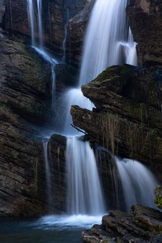 Beautiful waterfall cascading down cliff and boulders in Australian high country