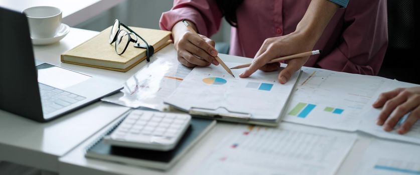 Financial Business team present. Business man hands hold documents with financial statistic stock photo, discussion, and analysis report data the charts and graphs. Finance Financial concept.