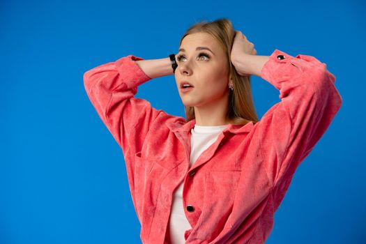 Negative nervous young woman in trouble over blue background