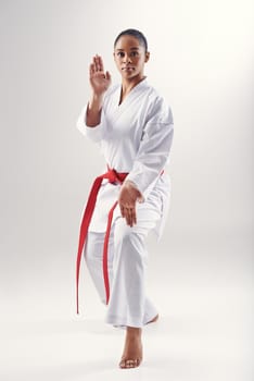 Discipline is at the heart of martial arts. An ethnic woman doing karate.