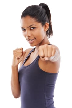 Dont mess with her. A fit young woman throwing a punch at you while isolated on a white background.