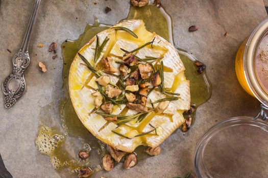 Delicious baked camembert with honey, walnuts, herbs and pears