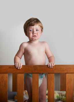 In need of a mothers care. Wailing toddler left alone in his crib.