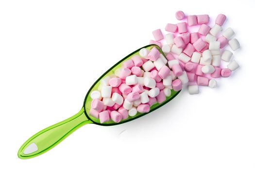 Mini marshmallows in plastic scoop on white background
