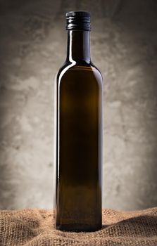 Blank glass bottle with olive oil, close up