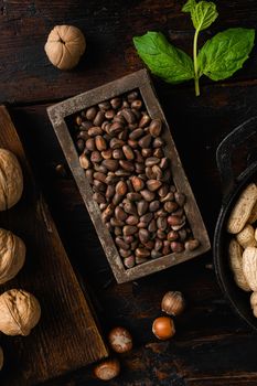 Pine wild organic nut, on old dark wooden table background, top view flat lay