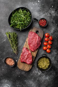 Fresh raw Beef meat Rump Steak, on black dark stone table background, top view flat lay