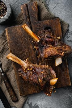 Baked whole lamb shanks meat, on gray stone table background, top view flat lay