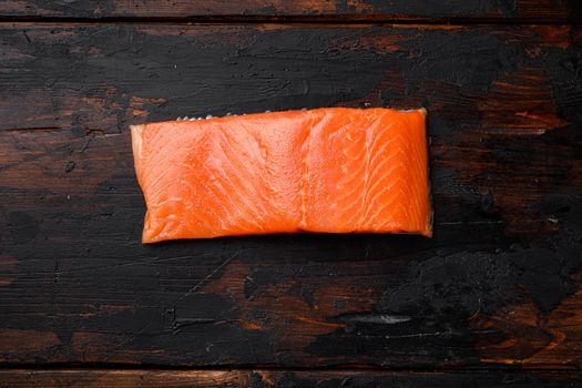 Raw Fillet of salmon, on old dark wooden table background, top view flat lay, with copy space for text