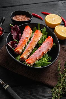 Snow crab legs, on black wooden table background