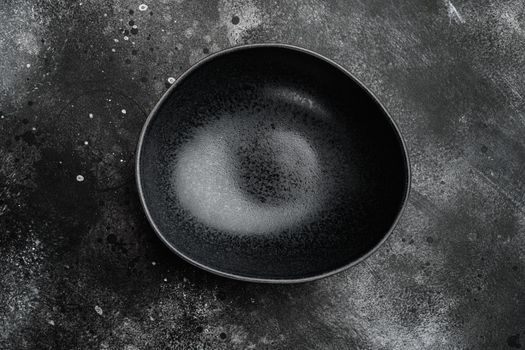 Empty black bowl, with copy space for text or food, with copy space for text or food, top view flat lay , on black dark stone table background