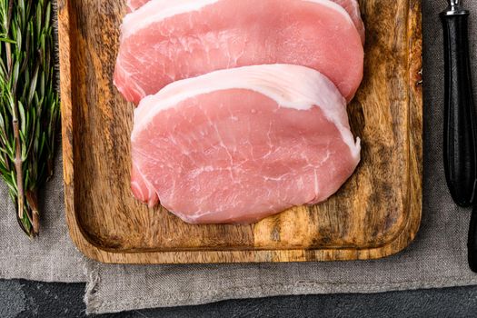 Pork meat. Fresh pork steaks, on gray stone table background, top view flat lay