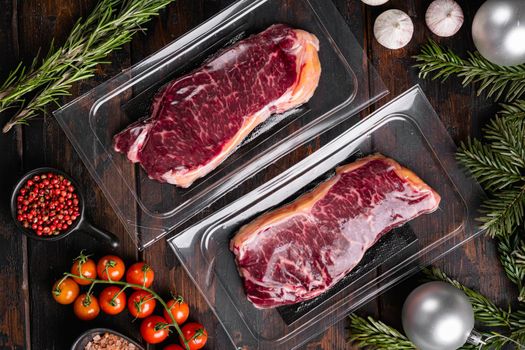 Beef marbled meat steak pack to the Christmas and New Year, on old dark wooden table background, top view flat lay