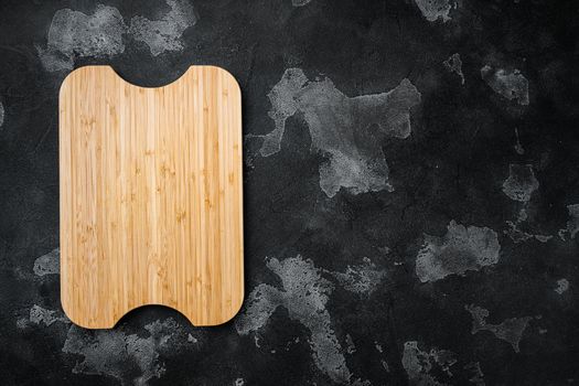 Empty vintage cutting board, on black dark stone table background, top view flat lay , with copy space for text or your product