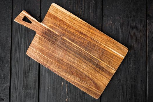 Used bamboo chopping board empty for empty for copy space for text or food, top view flat lay , on black wooden table background