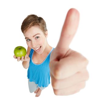 Say yes to healthy eating. Shot of a young woman eating an apple against a white background.