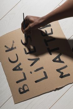 Black lives matter and fight against racism and write sign and words on cardboard - protest concept and blm activism