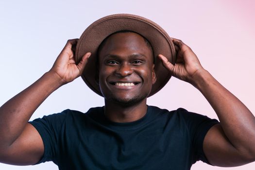 Smiling happy american african man wear stylish hat on white background. Festive and party concept