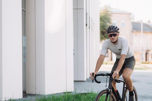 Caucasian cyclist in sport clothes riding bike outdoors