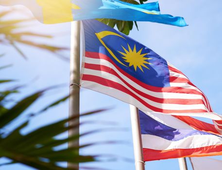 Fly it high, fly it proud. Shot of a Malaysian and Thailand flag blowing in the wind.