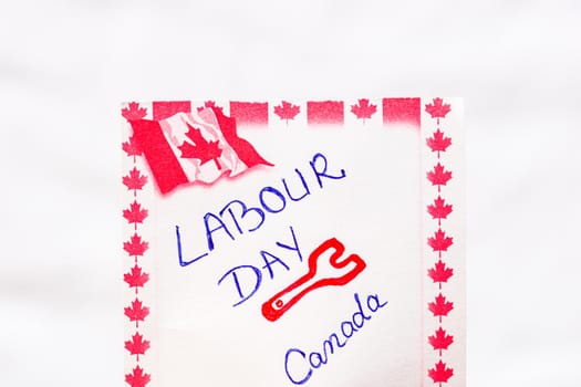 Labour day Canada handwriting on paper with Canada flag. Writing text on memo post reminder.Bucharest, Romania, 2020.