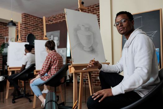 Portrait of smiling painter student attenting drawing class