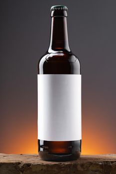 Blank label on the beer bottle on dark background.