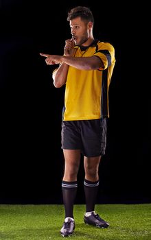 Ill be harsh but fair. Shot of a referee against a black background.