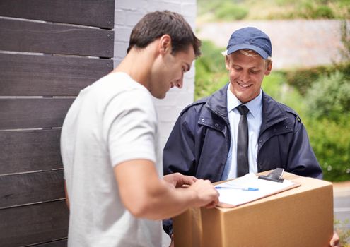 My parcel finally came. Shot of a young man receiving a parcel from the delivery man.