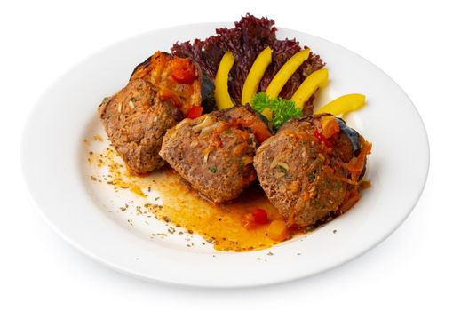 Meat balls with vegetables on white plate isolated on white