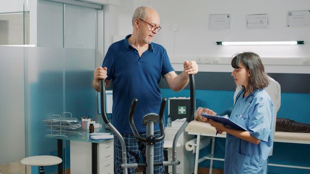 Senior patient doing recovery exercise on stationary bicycle