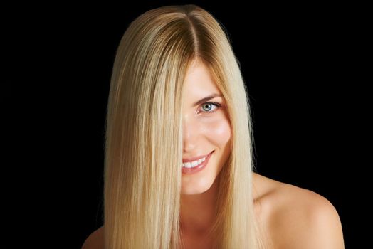 Lovely locks of blonde. Head and shoulders shot of a beautiful young woman.
