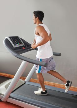 The heart also needs a workout. A young ethnic man running on a treadmill.