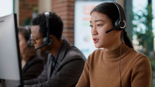 Telemarketing operator using headset to guide clients
