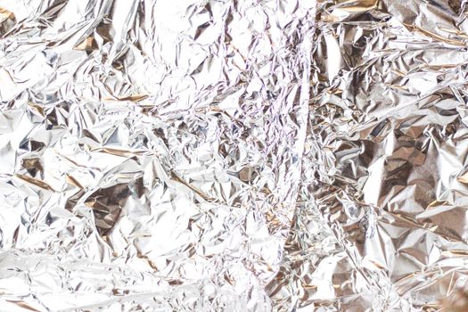 A soft background for a presentation made of crumpled foil. Graphic resources.  Stylish appearance, layout, personality. Selective focus. 