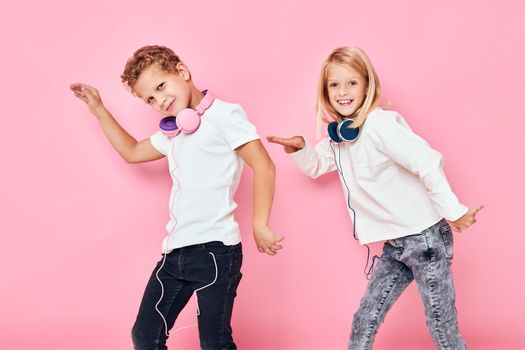 Funny children dancing with headphones entertainment lifestyle childhood. High quality photo