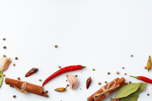 Variety of cooking spices on white background.