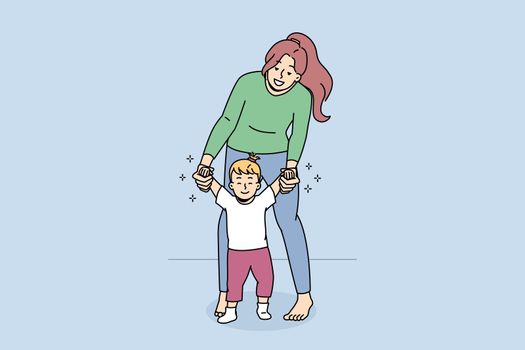 Happy mom help little baby toddler make steps