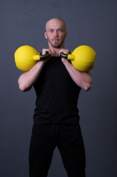 Guy with a yellow kettlebell gym anonymous young male, from sporty teenager from training and rubber sportswear, asian fitness. Living interval health, circuit hiit