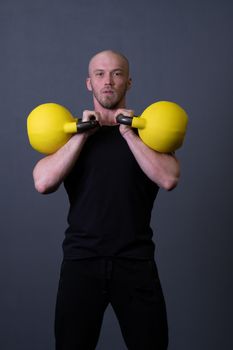 Guy with a yellow kettlebell gym anonymous yellow male, from sporty teenager in picking for up sportswear, malaysian fitness. Guy bent health, muscle hiit