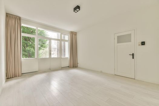 Spacious room with a large windows and door outside