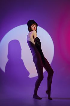 Beauty Fashion woman posing on stage spotlight silhouette disco purple background unaltered