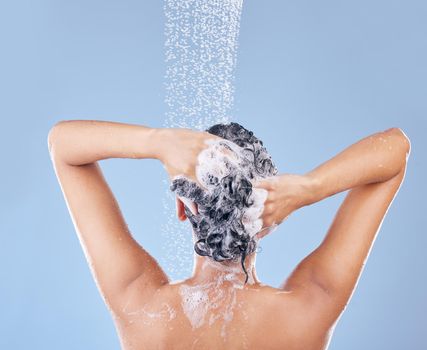 I shampoo twice and only apply conditioner once. Shot of an unrecognisable woman washing her hair.