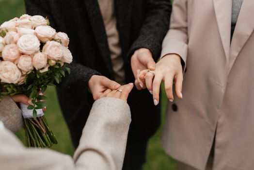 the bride and groom tenderly hold hands